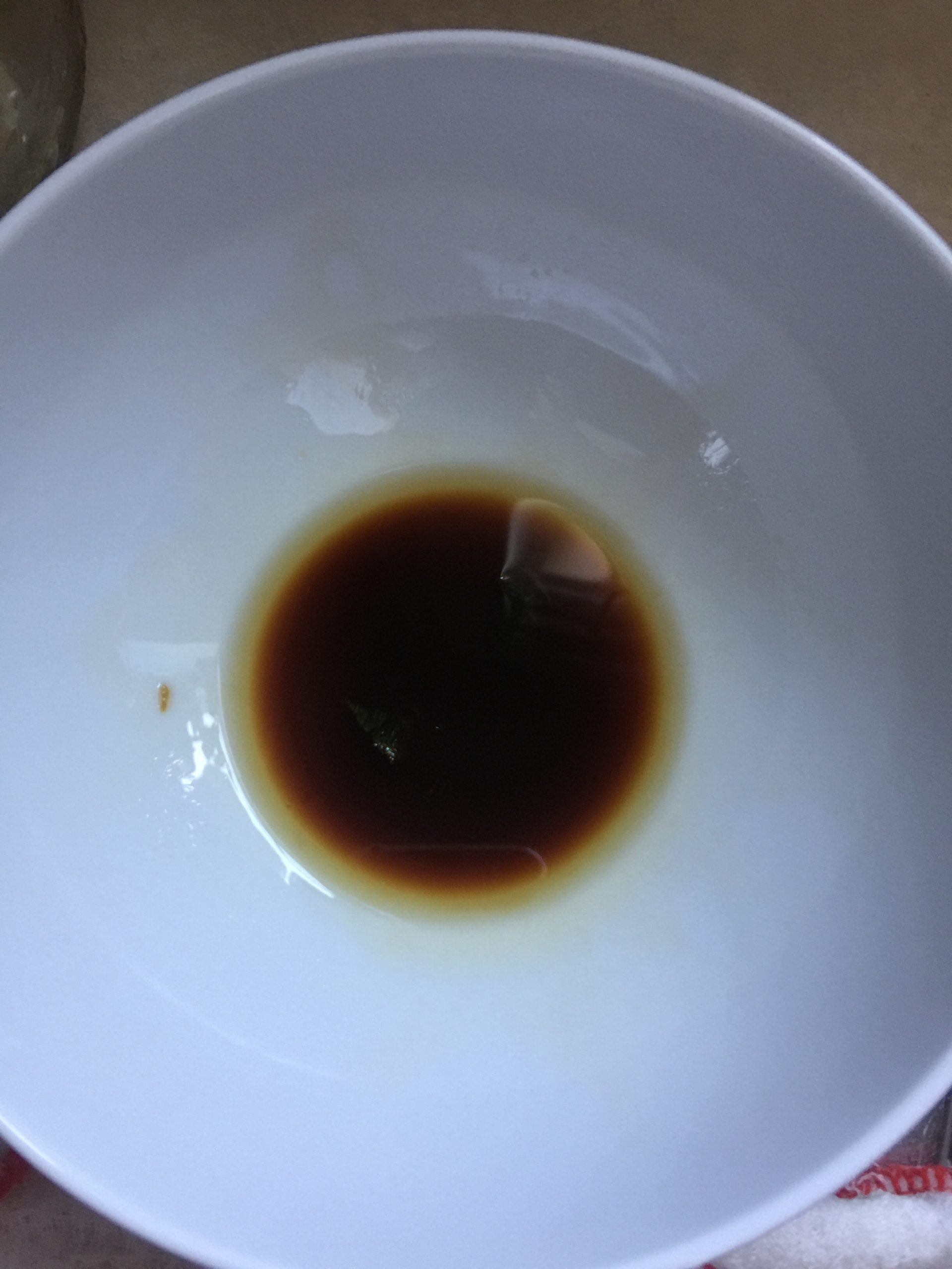A white bowl contains 1 tablespoon soy sauce and 1 tablespoon sesame oil
