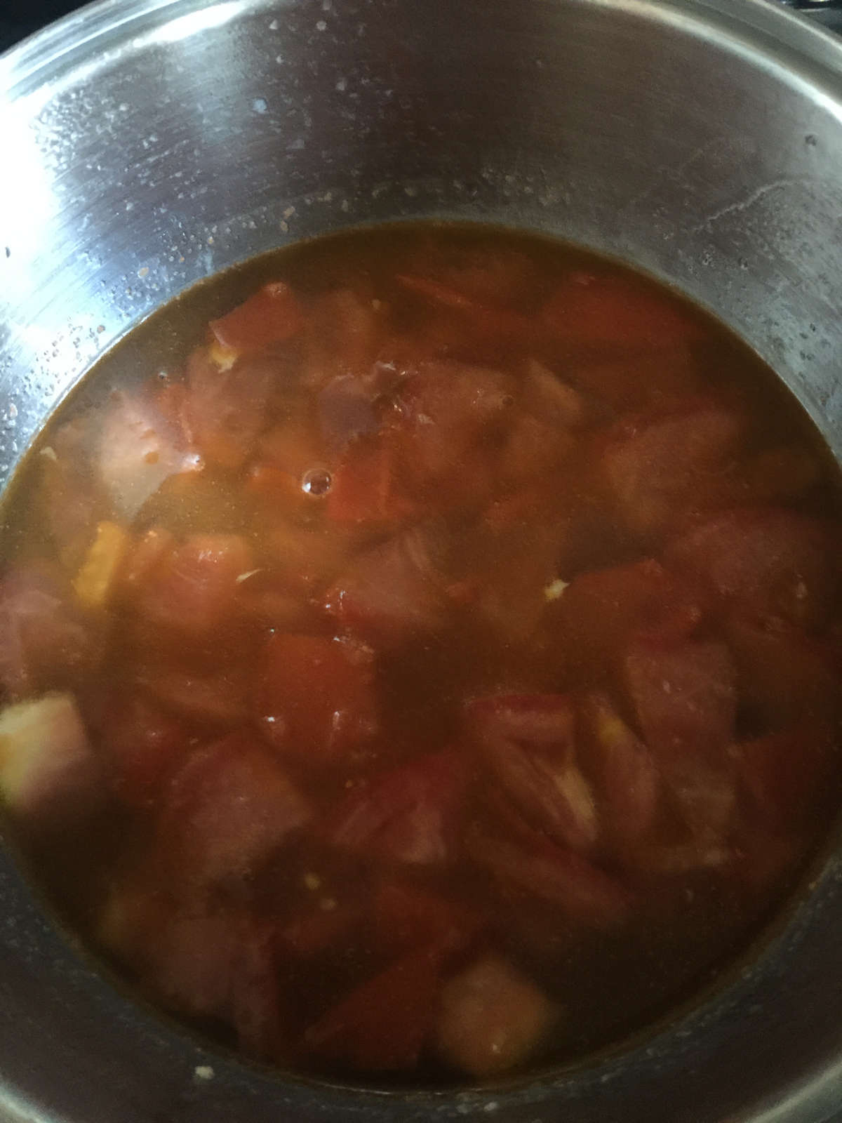 tomato chunks cooking in water in pot