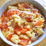 tomato egg noodle soup in a white bowl