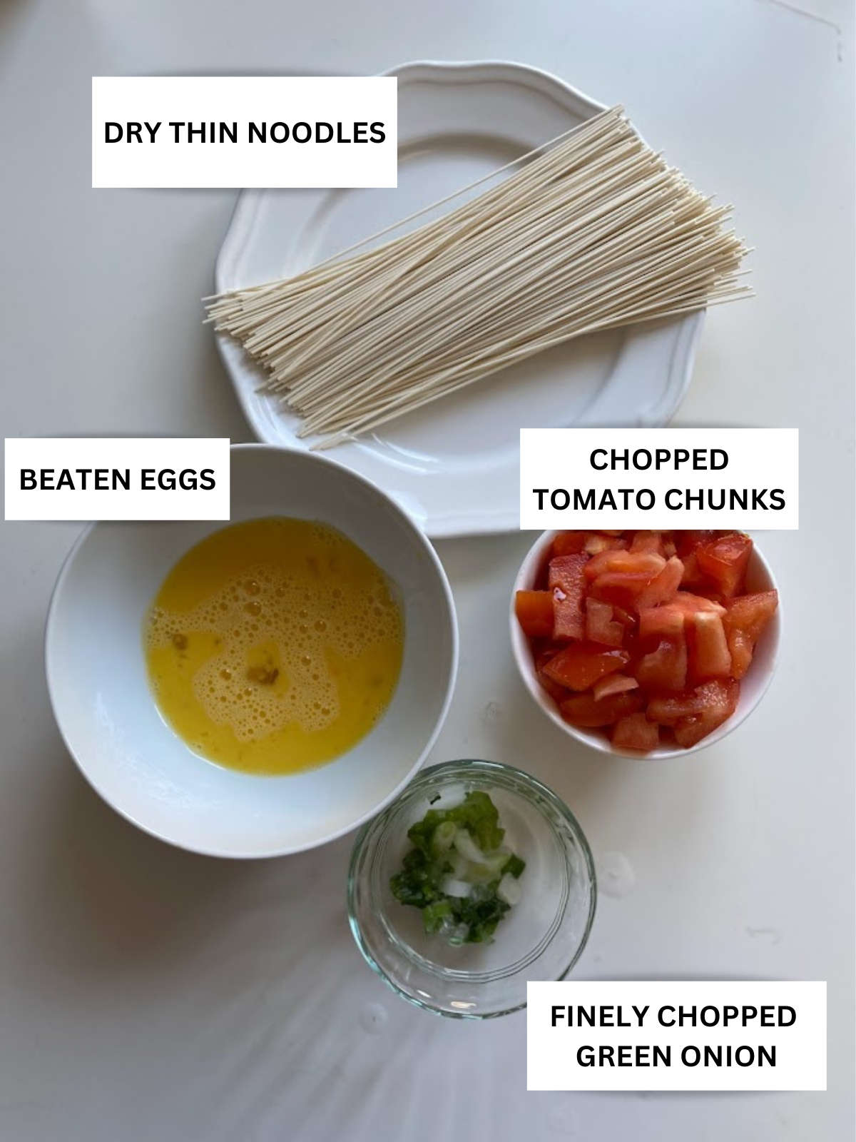 tomato egg noodles soup recipe main ingredients prepared and labeled