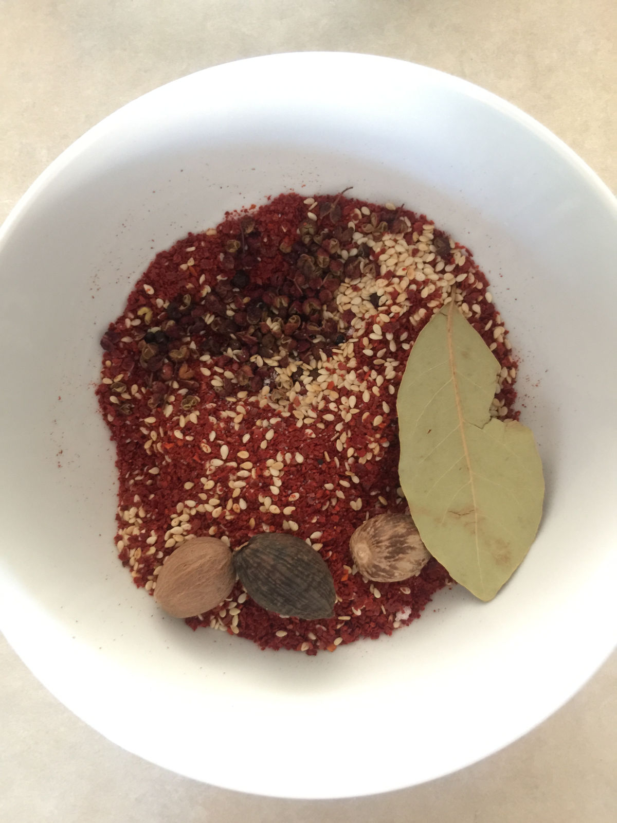 Overhead view of all dry ingredients placed in a white bowl.