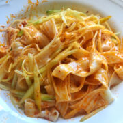 Close up view of a plate of cooked chili oil noodles.