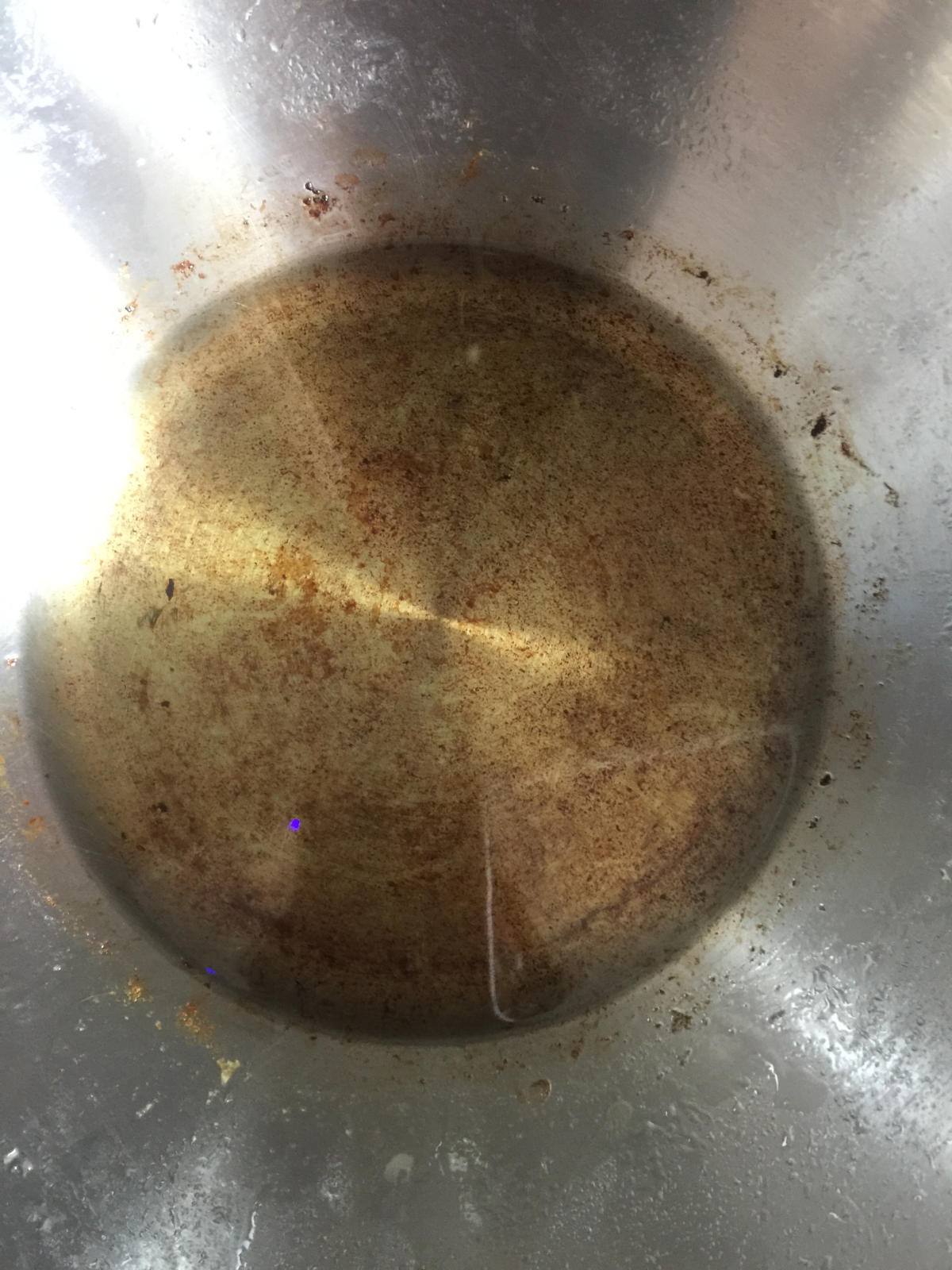 Scallion oil in stainless steel wok.