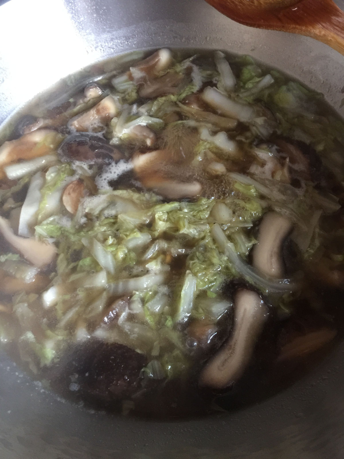 A close up view of vegetable soup with condiments (soy sauce, salt, sesame oil and sugar).
